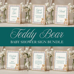 May include: A baby shower sign bundle featuring six framed signs with gold frames and a plaid design. Each sign has a teddy bear graphic and text such as "Cards & Gifts" and "Guest Book." The signs are arranged with white flowers in the background.