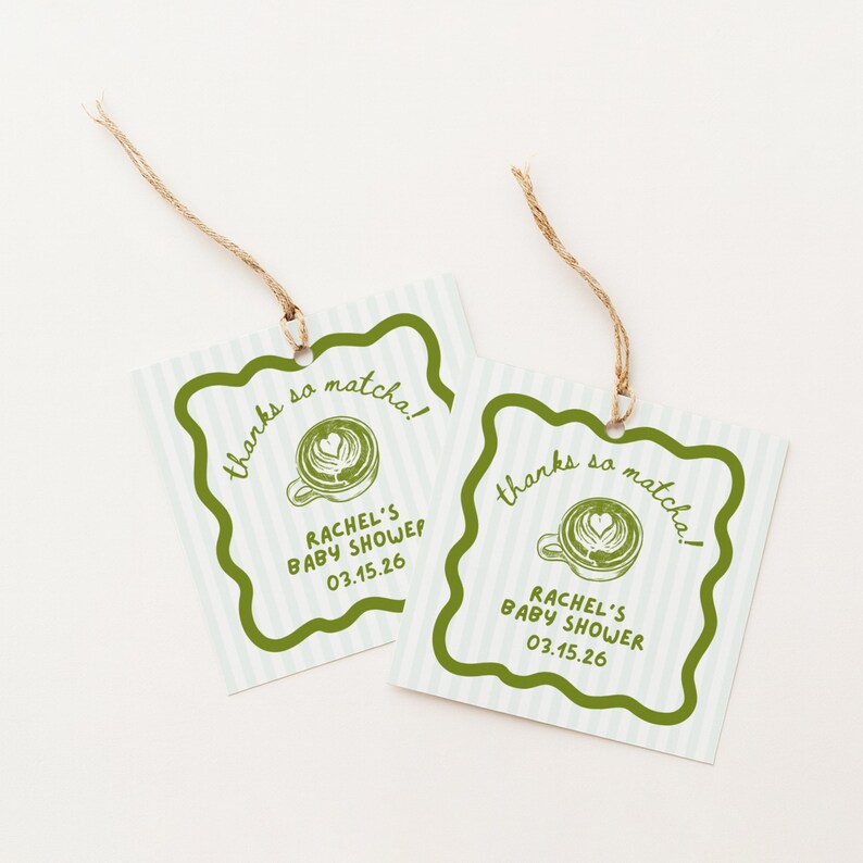 May include: Two square gift tags with a green scalloped border and a light blue striped background. The tags read "thanks so matcha!" and "RACHEL'S BABY SHOWER 03.15.26" with a matcha latte graphic. Each tag has a twine string.