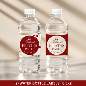 May include: Two clear plastic water bottles with white caps. Each bottle has a label with the text "Melissa's Pilates Party EST. 1999" in a burgundy circle. The bottom of the image reads "(2) WATER BOTTLE LABELS | 8.5X2".