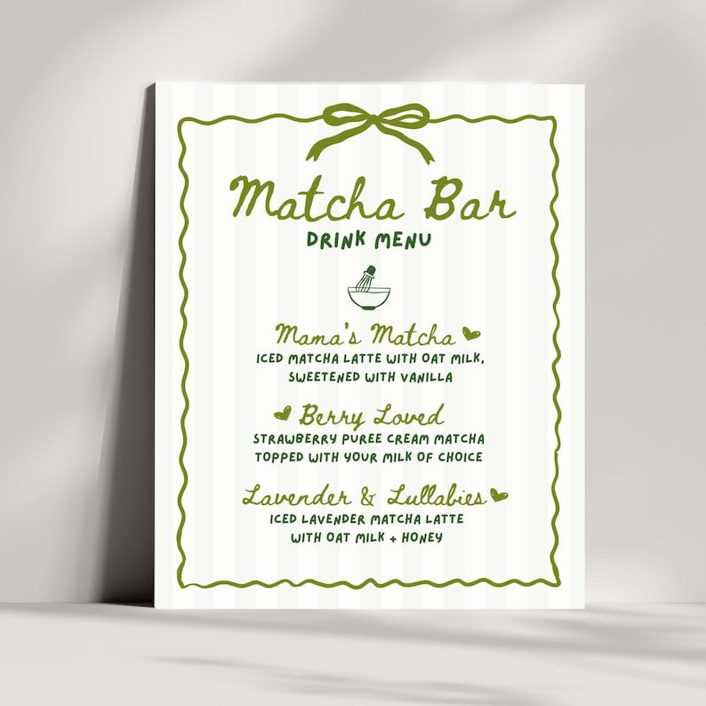 May include: A white Matcha Bar drink menu with green accents. The menu features a green bow at the top and a decorative green border. The menu lists three matcha latte options: Mama's Matcha, Berry Loved, and Lavender & Lullabies.