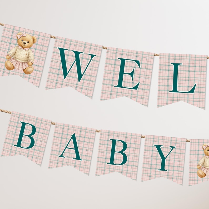 May include: A baby shower banner with the words "WELCOME BABY" in teal letters. The banner is made of pink and green plaid flags, with a teddy bear on each end. The teddy bears are wearing a sweater and skirt.