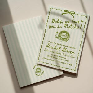 May include: Two baby shower invitations with a matcha theme. The front invitation reads "Baby, we love you so Matcha!" with details for Rachel Green's baby shower. The invitations are light green with a striped pattern on the back.