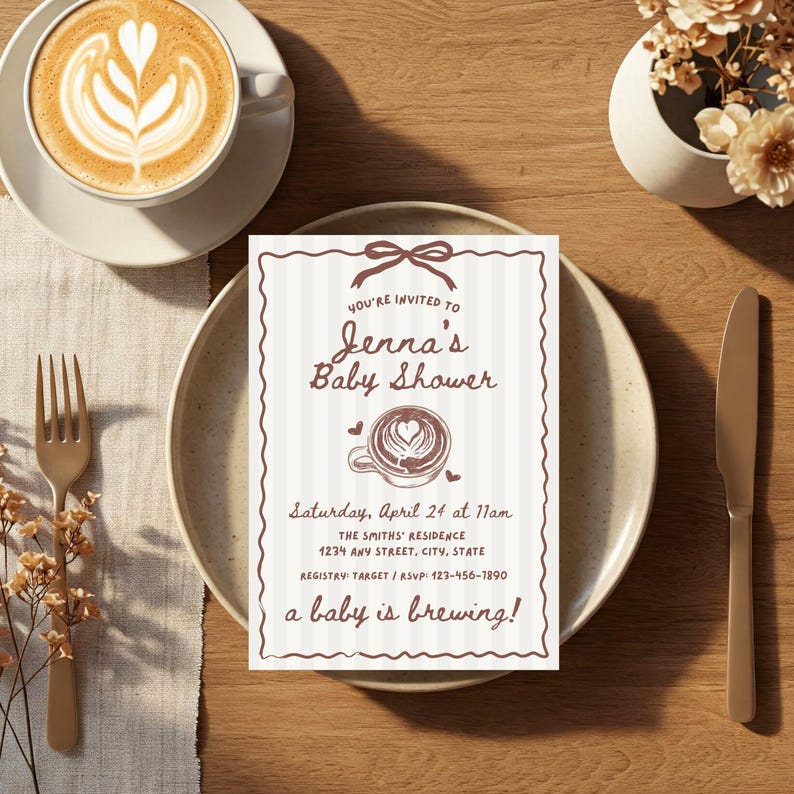 May include: A baby shower invitation with a coffee theme. The invitation is on a plate with a cup of coffee and a fork. The invitation reads "Jenna's Baby Shower" and "a baby is brewing!"