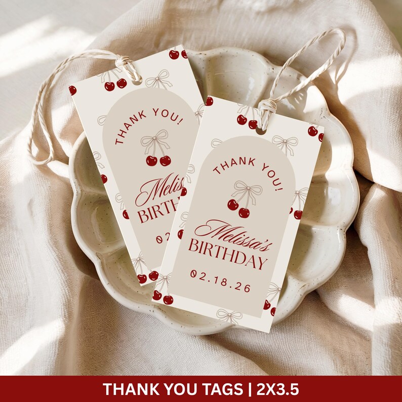 May include: Two beige gift tags with a cherry design and the text "Thank You!" and "Melissa's Birthday". The tags have a string for hanging. The bottom of the tags read "02.18.26".