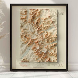 May include: Framed topographic map print featuring a detailed relief of a mountainous region. The map has a vintage aesthetic with brown and beige tones, and is encased in a black frame. Includes "FILE COPY" stamps.