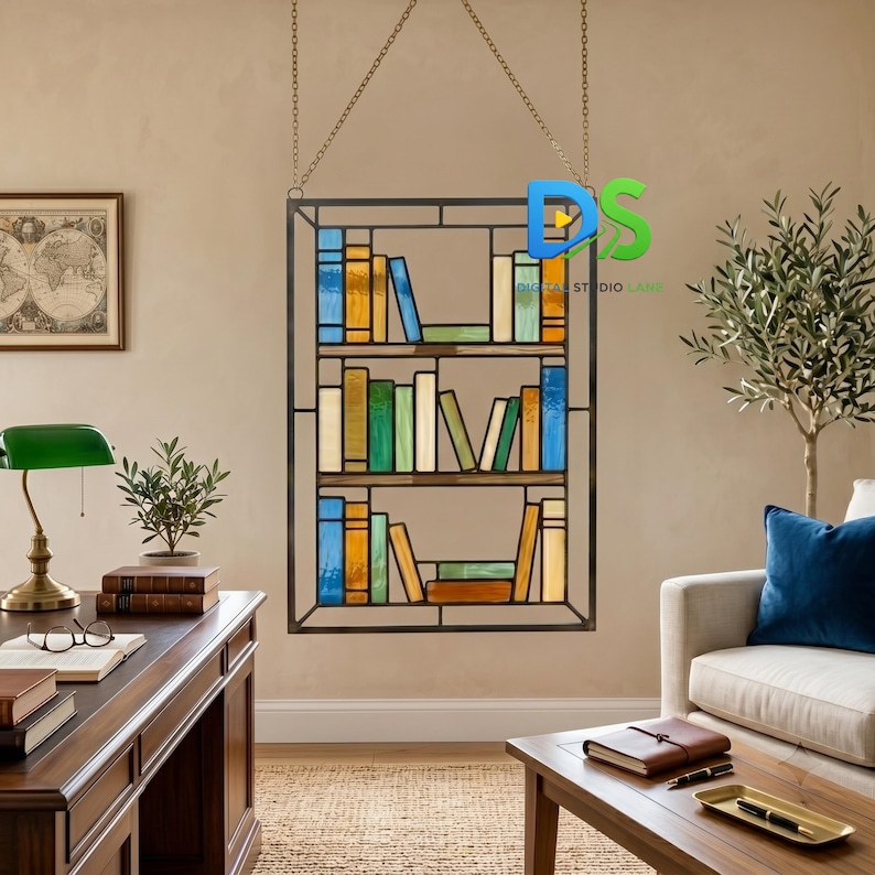 May include: A rectangular stained glass panel featuring a bookshelf design with three shelves filled with multicolored books in various shades of blue, green, yellow, and orange, suspended by thin metal chains from the top frame.