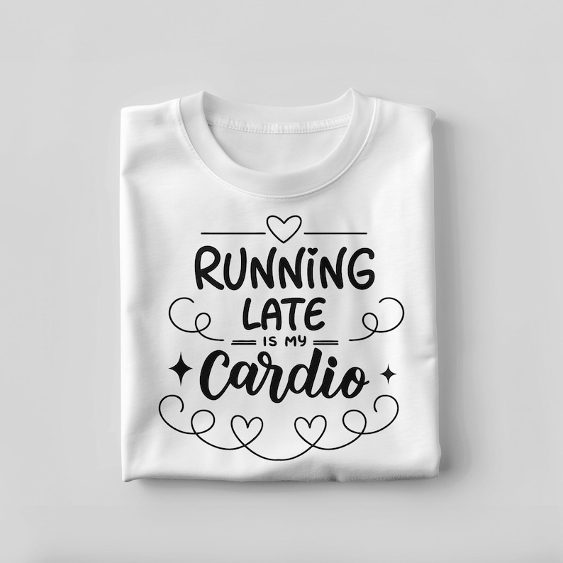 May include: White t-shirt with the phrase "RUNNING LATE IS MY Cardio" in black script. The design includes hearts and decorative swirls. The shirt is folded neatly.