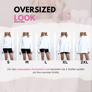 May include: White oversized sweatshirt with black shorts, displayed in multiple sizes from S to 2XL. The text "OVERSIZED LOOK" is at the top, with "GILDAN 18000" below it. The image suggests ordering two sizes larger for an oversized fit.