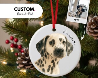 May include: A white ceramic Christmas ornament featuring a Dalmatian dog portrait with black spots. The ornament has a red ribbon for hanging and the name "Picasso" written on it. The text "CUSTOM Name & Bild" is also visible.