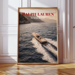 Luxury yacht speeding across the ocean at sunset with coastal mountains in the background, styled as elegant coastal lifestyle wall art.