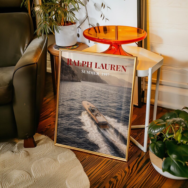 Luxury yacht speeding across the ocean at sunset with coastal mountains in the background, styled as elegant coastal lifestyle wall art.