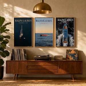 May include: Three rectangular wall posters featuring Ralph Lauren Summer 1997, 1998, and 1999 branding. The left poster shows a sailboat on dark water, the center shows a red boat on a calm sea, and the right shows a blue boat cutting through white waves.