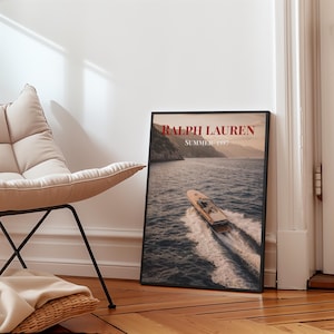 Luxury yacht speeding across the ocean at sunset with coastal mountains in the background, styled as elegant coastal lifestyle wall art.