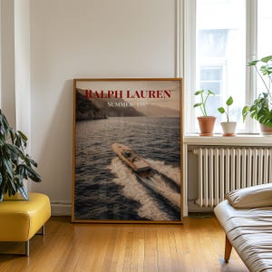 Luxury yacht speeding across the ocean at sunset with coastal mountains in the background, styled as elegant coastal lifestyle wall art.