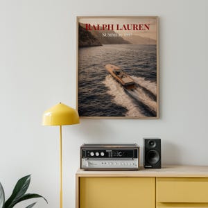 Luxury yacht speeding across the ocean at sunset with coastal mountains in the background, styled as elegant coastal lifestyle wall art.
