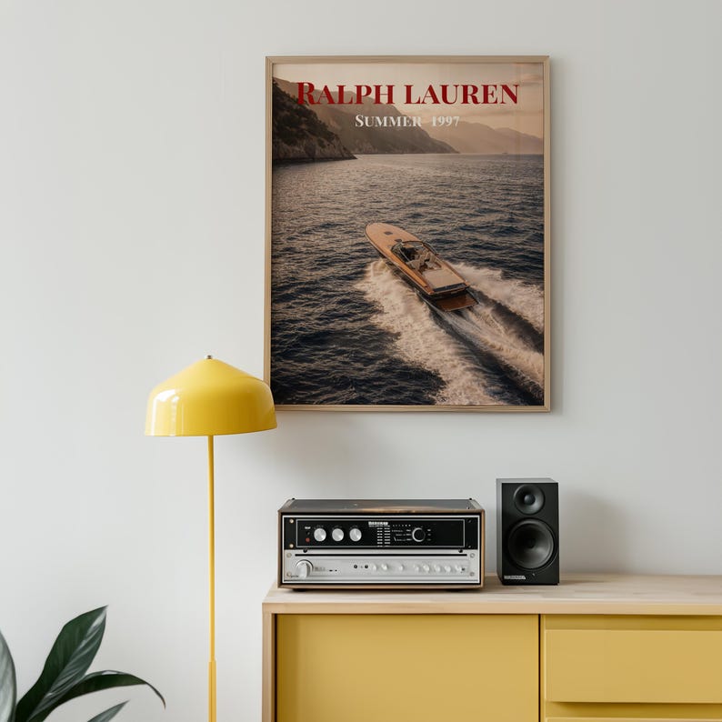 Luxury yacht speeding across the ocean at sunset with coastal mountains in the background, styled as elegant coastal lifestyle wall art.