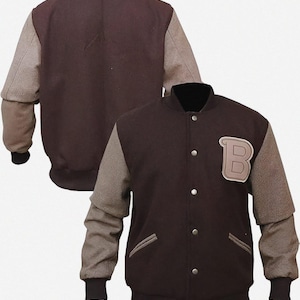 May include: A maroon and grey letterman jacket with a black collar and cuffs. The jacket features a large letter "B" patch on the chest and a button-up front. The sleeves are grey, and the body is maroon.