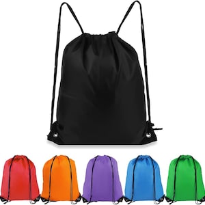 May include: A black drawstring backpack with thin black cord straps and metal grommets at the bottom corners. Below, five additional drawstring backpacks are displayed in a row, featuring solid red, orange, purple, blue, and green colors.
