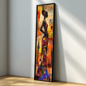 Pode incluir: Uma obra de arte emoldurada com a silhueta de uma mulher em um vestido longo. A obra de arte tem um design abstrato com tons de laranja, amarelo, azul e vermelho. A moldura preta contrasta com a obra colorida, encostada em uma parede branca.