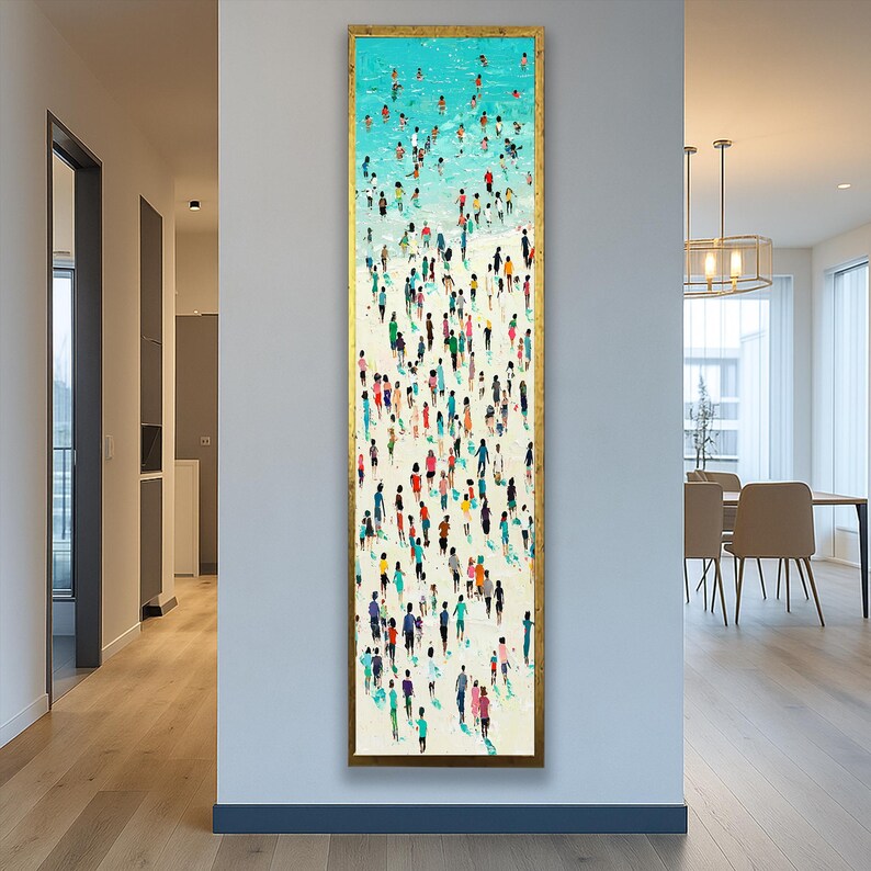 May include: A long, vertical framed painting depicts a beach scene with numerous figures. The top portion shows a turquoise ocean with swimmers, transitioning to a sandy beach filled with people in various colorful outfits. The frame is gold.
