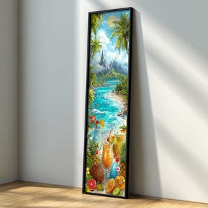 May include: A framed vertical art print depicting a tropical beach scene with turquoise water, palm trees, and a mountain in the background. The foreground shows cocktails and fruit. The frame is black.