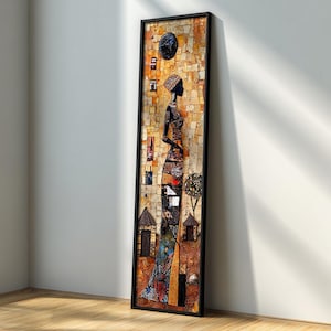 Puede incluir: Una obra de arte en mosaico enmarcada que representa a una mujer africana de perfil. La obra presenta un marco negro, un fondo de mosaico con tonos cálidos y una figura detallada con un vestido y un tocado estampados. La obra está apoyada contra una pared blanca.