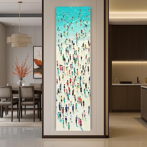 May include: Vertical abstract painting of a beach scene with a turquoise ocean and a sandy shore. Numerous small figures in various colors represent people on the beach and in the water. The artwork is displayed in a modern interior setting.