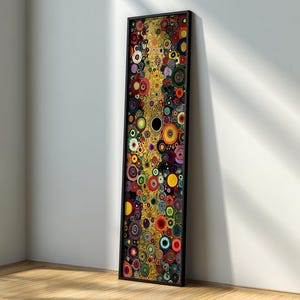 Puede incluir: Una impresión artística abstracta enmarcada con una composición vertical de círculos coloridos. La obra de arte presenta una variedad de colores, incluyendo dorado, rojo, amarillo y azul, creando un diseño vibrante. El marco es negro.