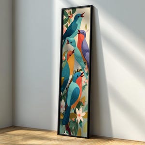 May include: A framed vertical art print featuring a colorful illustration of six stylized birds perched on branches with flowers. The birds are in shades of blue, orange, and purple, set against a light green background. The frame is black.