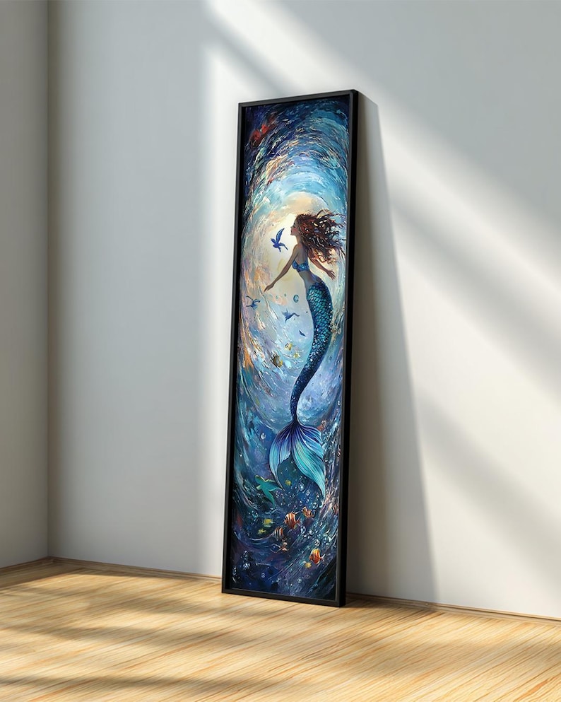 May include: A framed vertical art print featuring a mermaid in a swirling underwater scene. The mermaid has flowing auburn hair and a blue tail. The artwork is predominantly blue with accents of orange and green, creating a vibrant aquatic theme.
