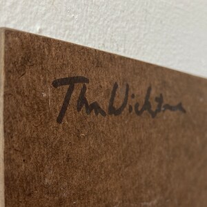May include: A brown wooden surface with a black signature that reads "The Wichita" in cursive.