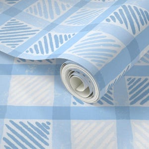 May include: A roll of light blue and white patterned wallpaper. The design features a gingham pattern with diagonal stripes and abstract shapes. The wallpaper is partially unrolled, revealing the pattern.