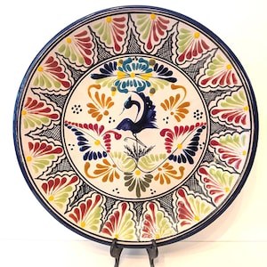 May include: A set of three ceramic mugs with a speckled, cream-colored glaze. Each mug features a different hand-painted floral design in shades of blue, green, and yellow. The mugs have a simple, modern shape.