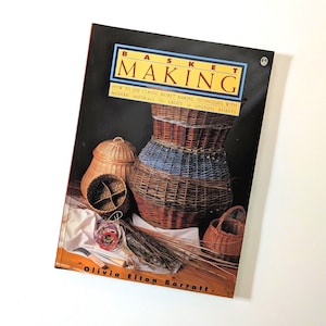 May include: A book titled "BASKET MAKING" with a black cover, featuring various woven baskets in shades of brown, blue, and tan. The book cover displays the title in a yellow and blue box, with text below describing the book's content. A variety of basketry tools are also visible.