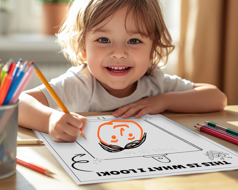 May include: A child is drawing a self-portrait on a sheet of paper. The paper has the text "THIS IS WHAT I LOOK LIKE!" and "THIS IS ME". A pencil is in the child's hand. Colouring pencils and a pencil are on the table.
