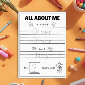 May include: A white "All About Me" worksheet with the name "Oliver" and the word "Boy" printed on it. The worksheet also includes the number "3" and the words "Years Old". The worksheet is surrounded by colourful crayons and markers.