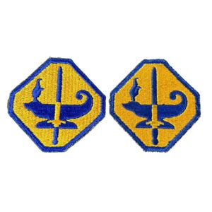 May include: Two yellow octagonal patches with blue embroidered designs. Each patch features a sword, a lamp, and a ship's prow.