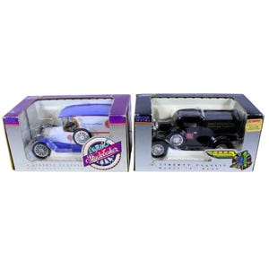 May include: Two vintage toy car banks, one blue and white 1916 Studebaker and one black 1929 Ford Model A. Both are die-cast metal and feature a Liberty Classic logo.