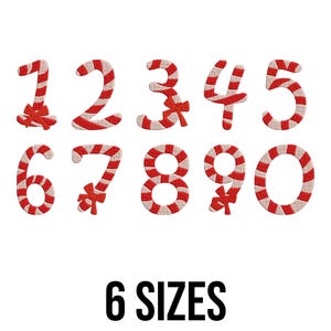 May include: A collection of embroidered numbers 0-9 in a candy cane design with red and white stripes and a red bow. The text "6 SIZES" is displayed in black below the numbers, set against a white background.