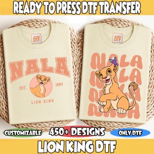 May include: Two cream-colored t-shirts with DTF transfers featuring Lion King designs. One shirt displays "NALA" with a lion cub graphic, the other has "NALA" repeated with a lion cub. Text includes "READY TO PRESS DTF TRANSFER" and "450+ DESIGNS".