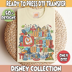 May include: A cream colored t-shirt with a colorful graphic design featuring the text "Walt Disney World" and an illustration of a robot. The design includes various iconic Disney World landmarks and characters. The text "Orange DTF" is visible on the shirt.