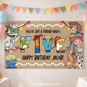 May include: A rectangular birthday banner with a kraft paper background featuring Toy Story characters including Buzz Lightyear, Woody, Jessie, Bullseye, Forky, and an alien. The text reads: YOU'VE GOT A FRIEND WHO'S FIVE HAPPY BIRTHDAY JACOB!