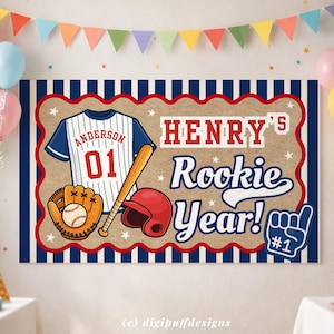 May include: A baseball-themed banner with a jersey, bat, glove, and helmet. The jersey says "Anderson 01". The banner reads "Henry's Rookie Year!" in white and red. The background is tan with blue and white stripes.