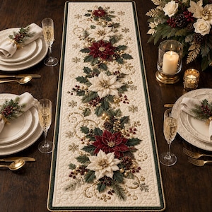 May include: A rectangular cream-colored table runner featuring an embroidered pattern of red and white poinsettia flowers, green holly leaves, gold swirls, and snowflakes, finished with a dark green border and gold piping on a wooden table.