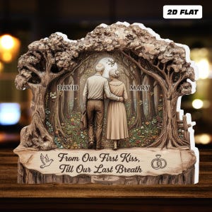 May include: A 2D flat wooden plaque featuring a couple walking in a forest, with the names "David" and "Mary" on either side. The plaque includes the text "From Our First Kiss, Till Our Last Breath" and a dove and wedding rings.