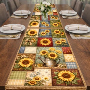 May include: A rectangular table runner featuring a patchwork design with sunflower motifs. The runner showcases various squares with sunflowers, watering cans, and floral patterns in shades of yellow, green, and brown. The edges are trimmed with a decorative fringe.