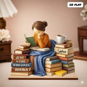 May include: A figurine of a person reading, surrounded by stacks of books. The person is wearing an orange shirt and blue blanket, with a coffee mug nearby. The books have the text "Just a girl who loves books" and the name "Sophia".