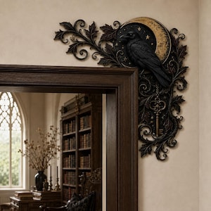 May include: A decorative corner wall accent featuring a black raven perched on a gold crescent moon. The piece is adorned with intricate dark brown scrollwork, leafy foliage, small gold stars, and a hanging skeleton key design element.
