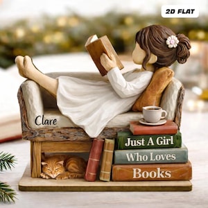 May include: A figurine of a person reading a book while reclining on a small sofa. A cat sleeps beneath the sofa. The figurine has the text "Clare" on the sofa and the text "Just A Girl Who Loves Books" on the books.