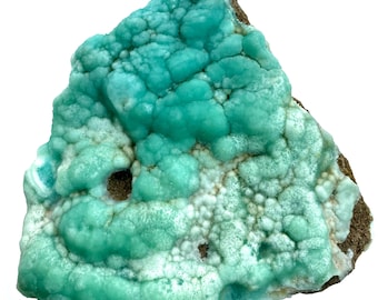May include: A vibrant, teal-colored mineral specimen with a bubbly, textured surface. The stone has a rough, brown base and a mix of light and dark teal hues. The overall shape is irregular, showcasing natural formations.